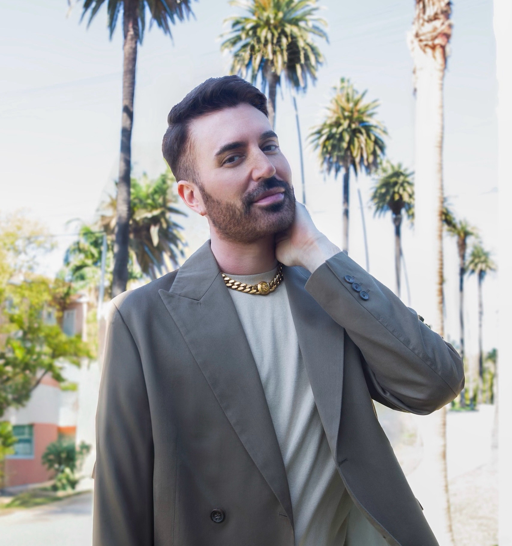 Matthew Addison outdoors with palm trees behind him